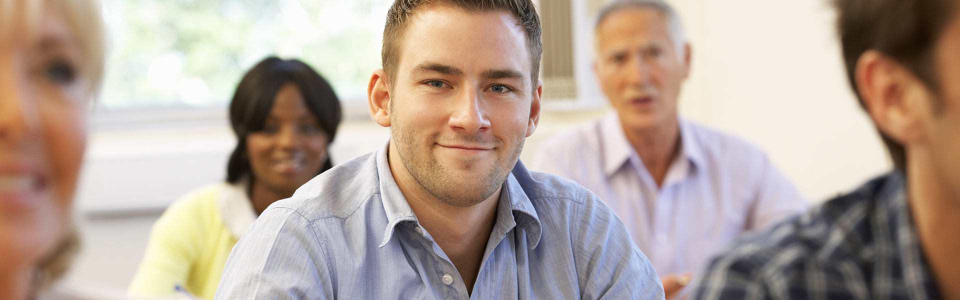 Adult student smiling in class with other students