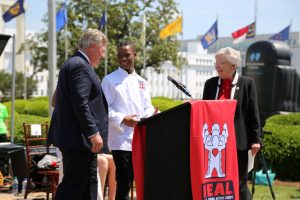 Two Man and a Woman at a Podium