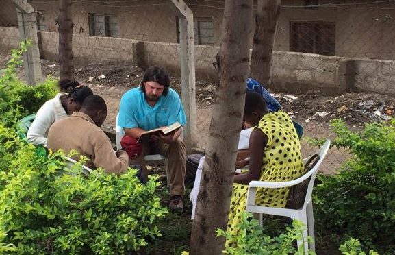 Justin Maynard teaches a Bible class to a group in Tanzania, Africa.