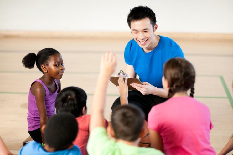 A teacher and students in an elementary physical education class