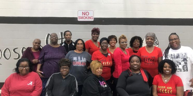 Cyd Howard, front row, sits among women with the nonprofit KOSQS, which aids the underserved in Birmingham.