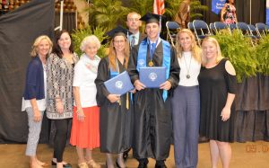 Tammy Wilson and Hunter Wilson, center, stood with family and friends following their graduation from Faulkner University. 