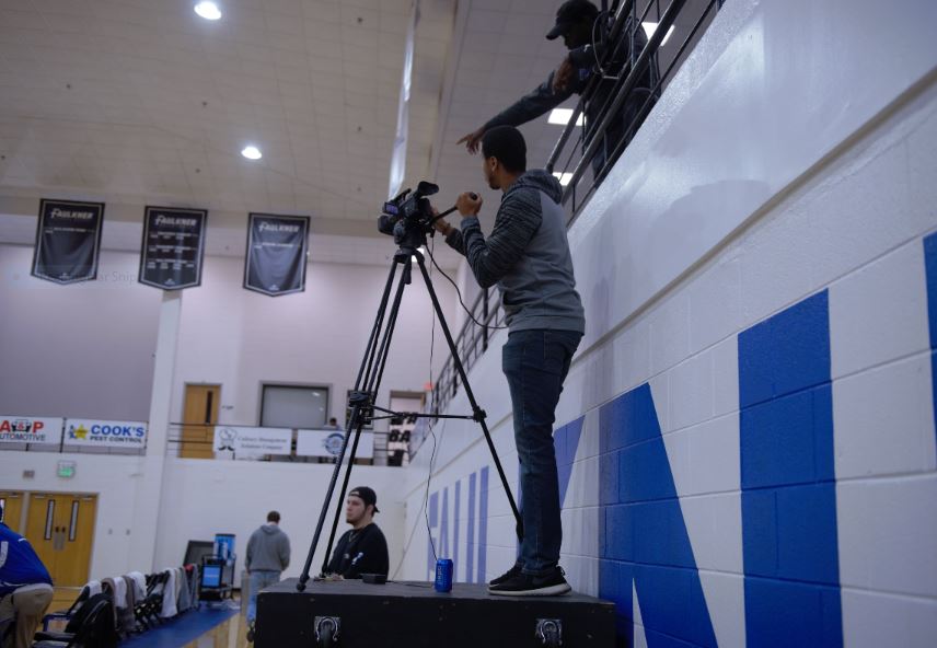 Jacob Hartsfield with the Faulkner Sports Network mans the camera during this season's games while Keavonte' Lindsey assists in the balcony. 