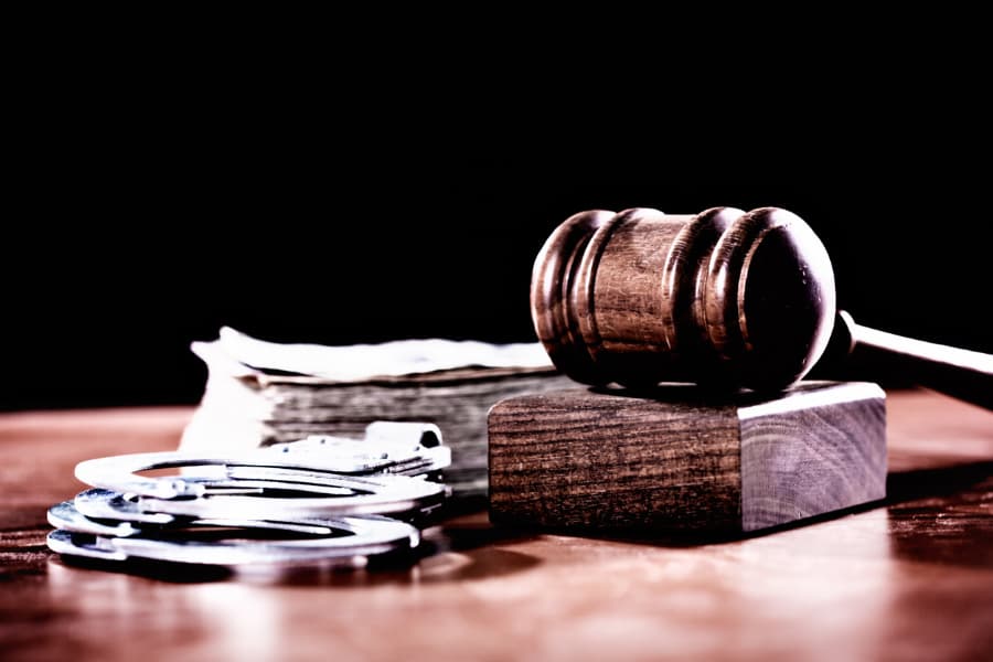 Gavel with banknotes and handcuffs