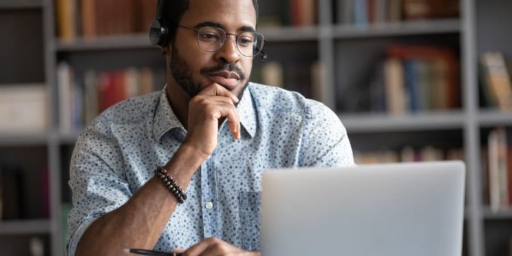 A young man studies online