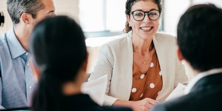 Human resources manager meets with coworkers