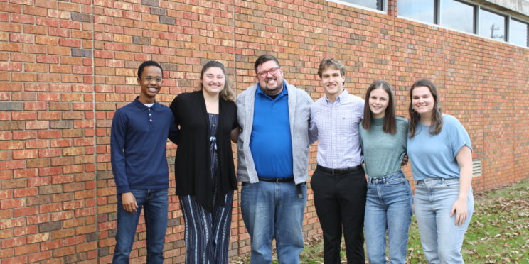 Faulkner chapter of Students for Life stand together outside the library on Faulkner's campus.