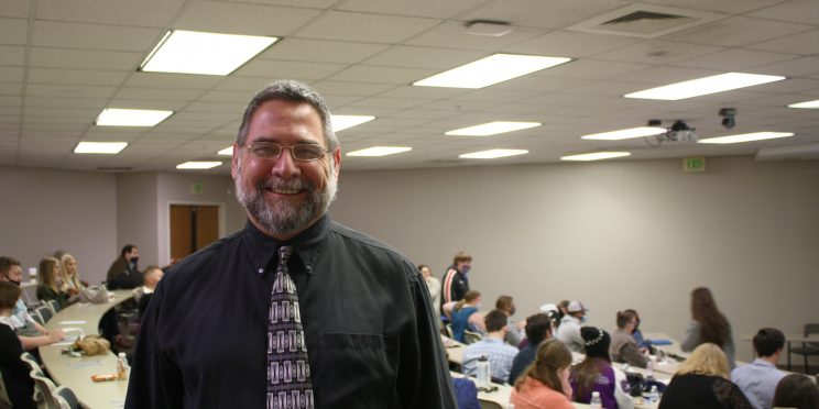 Franklin "Buddy" Renahan is an adoption family counselor. He stands in an auditorium full of students ready to speak during the Marketplace Faith Friday Forums 2021.