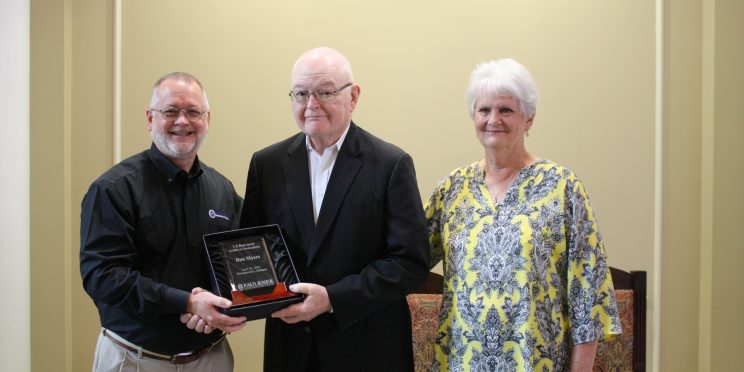 l-r Scott Gleaves, don Myers and Judy Myers. Gleaves presents Don Myers with a commemorative plaque during his retirement ceremony.