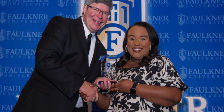 President Mitch Henry awards education alumna Indyia Rachel