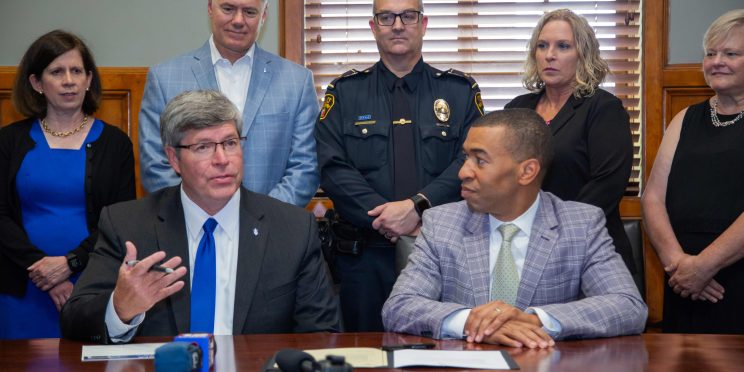 President Mitch Henry speaks at a press conference at City Hall as a partnership is signed between Faulkner and MPD.