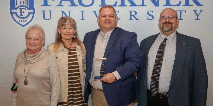 Paul Spurlin, center, stands with his family and Dr. Todd Brenneman. Spurlin is the connections minister at Piedmont Road Church of Christ.