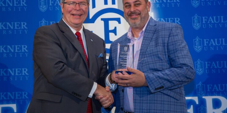 Ryan Frederick receives the Distinguished Alumnus Award from Faulkner President Mitch Henry.