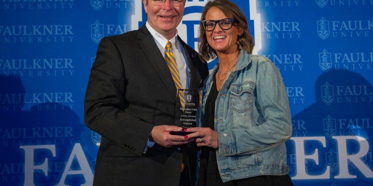 President Mitch Henry awards Ashley Abrams with the Accomplished Alumna Award.