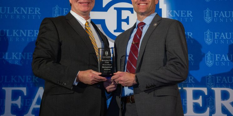 President Mitch Henry awards Captain Daniel Phipps at the 2024 Marketplace Faith Friday Forums.