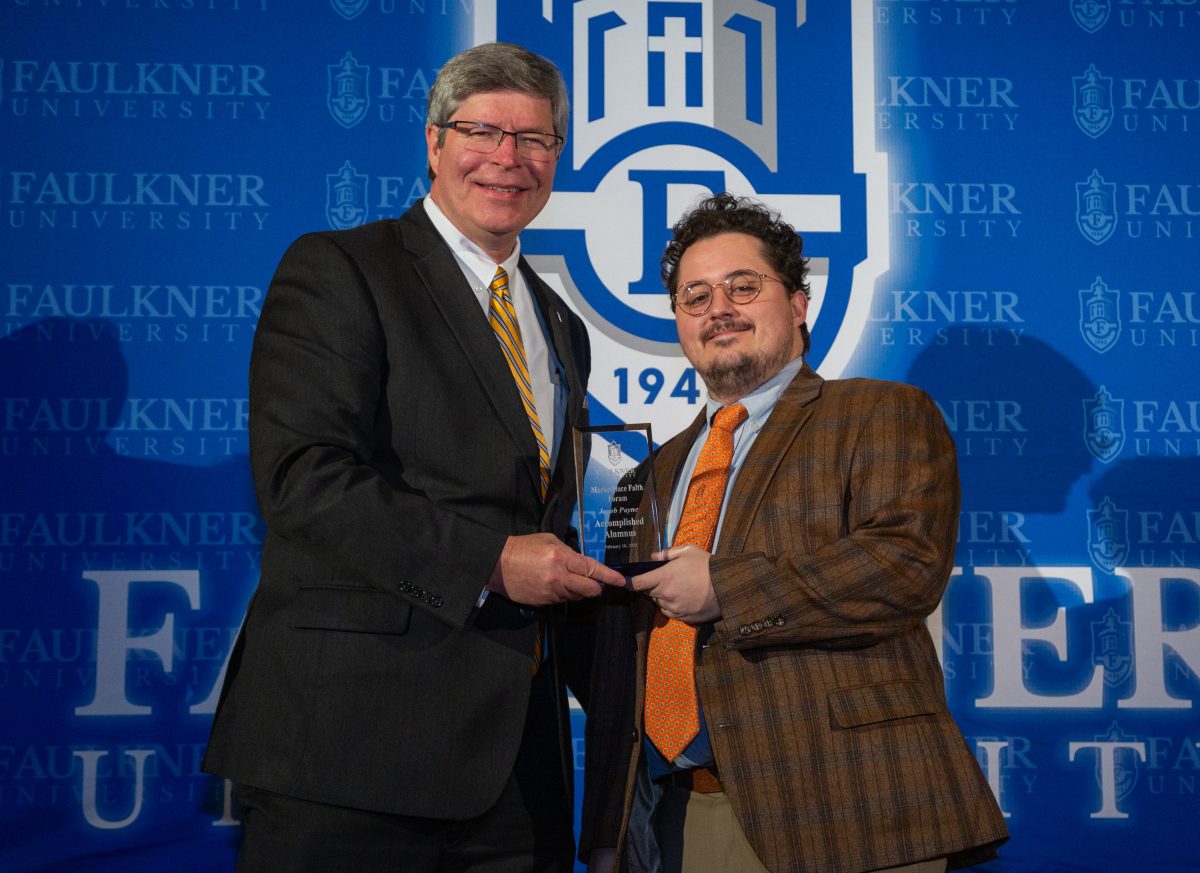 President Mitch Henry awards Jacob Payne. Payne works as a lawyer in Dothan, Alabama.
