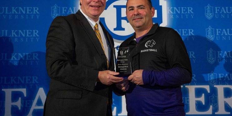 Faulkner President Mitch Henry, left, presents Jason Roberson with the Distinguished Alumnus Award.