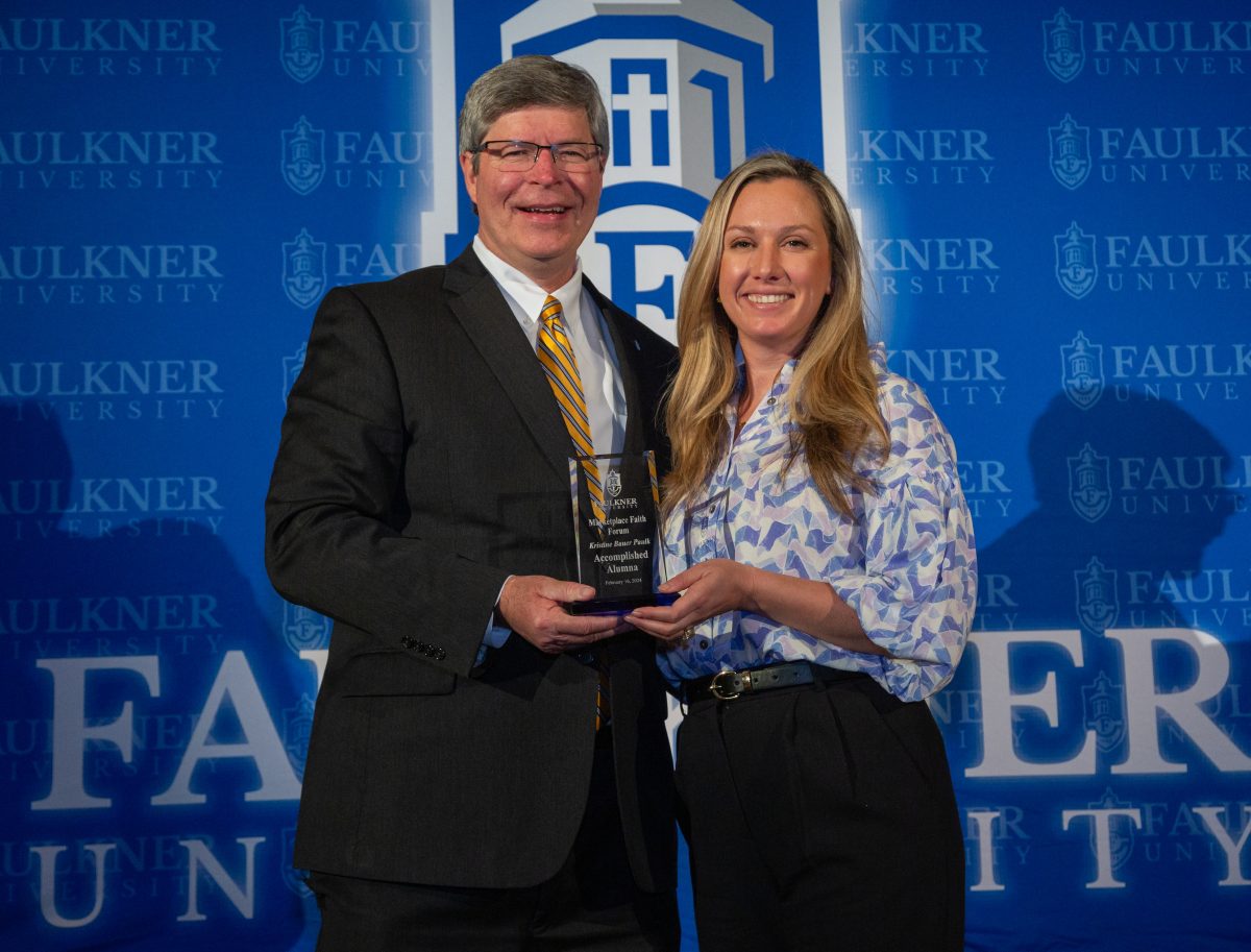 President Mitch Henry awards Kristine Paulk with the College of Health Sciences' Accomplished Alumna Award.