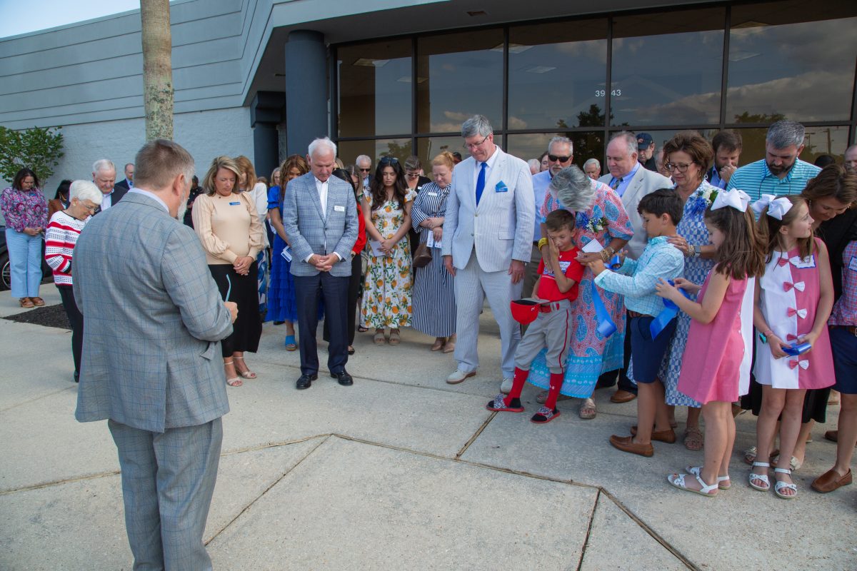Brannon Lentz leads a prayer during the dedication ceremony of the Mobile campus.