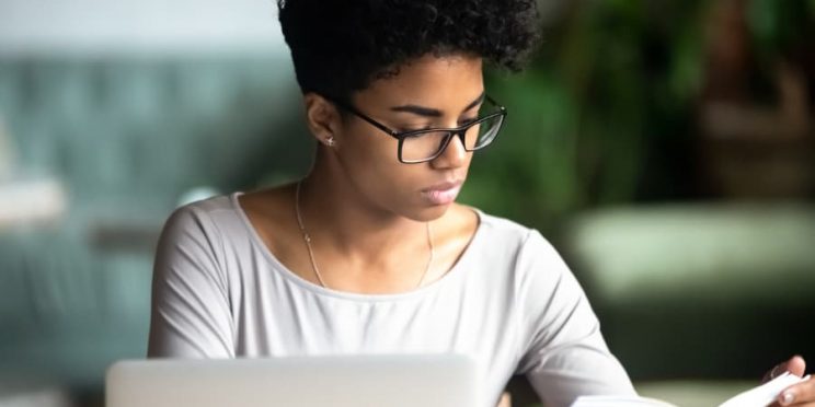 Business Student Taking Notes On Laptop