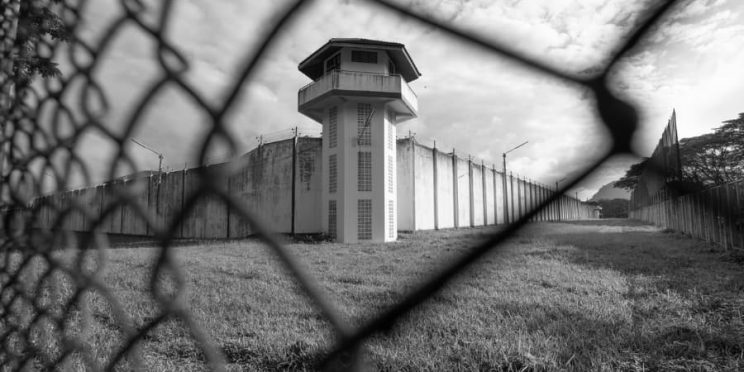 State penitentiary seen through chain-link fence