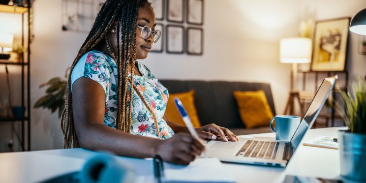 Online degree student studies with laptop at home