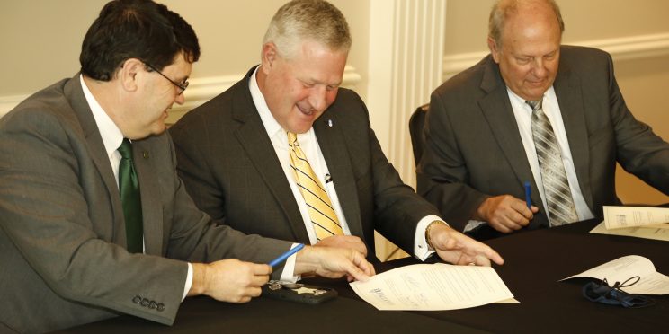 l-r W. Kirk Brothers, Mike Williams and Dale Kirkland sign a Memorandum of Understanding on Faulkner’s Montgomery campus on September 30, 2021.