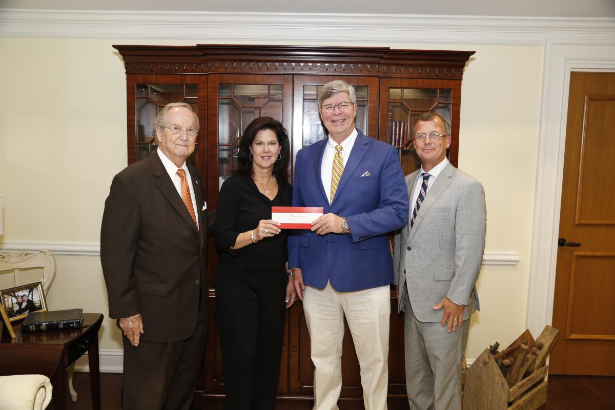 l-r- Faulkner Vice Chancellor Wayne Baker, Alabama Power Vice President of the Southern Division Leslie Sanders, Faulkner President Mitch Henry, Alabama Power External Affairs Manager Mike Jordan stand in Henry's office as they present a check to Faulkner.