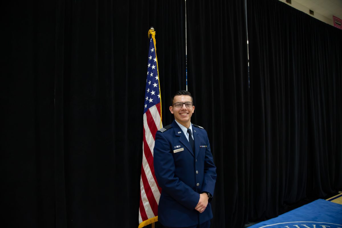 Michael Wooldridge stands by the United States flag and is the ROTC Wing Commander.