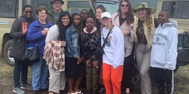 Faulkner students and group leaders, Dr. Rick Trull pose with others during their mission trip to Tanzania.