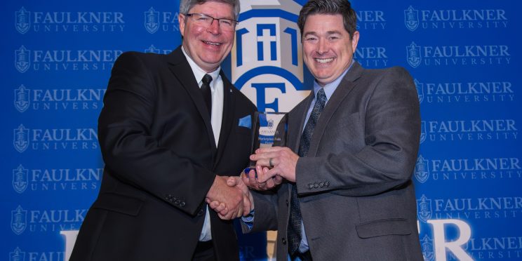 President Mitch Henry awards Trae Durden with the Distinguished Alumnus Award.