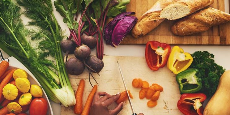 Vegetables Being Chopped Up on Cutting Board