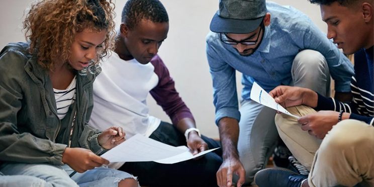 Four College Students Working on a Group Project