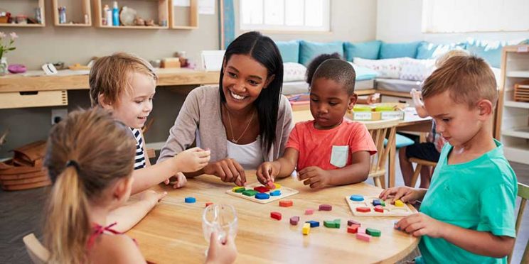 Education Student Playing with Children at Table
