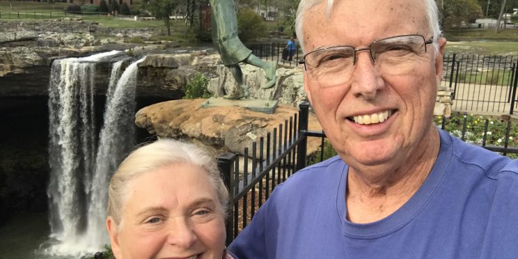 Peggie and Randall Haney pose in front of Naccalula Falls in Gadsden, AL. He shares how God's blessings afforded him the opportunity to support Faulkner.