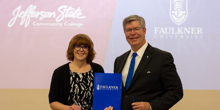 Dr. Danielle Coburn, left, and President Mitch Henry pose for a picture after signing the MOU.