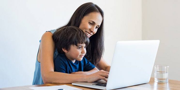 Mother Using Laptop with Son on Lap