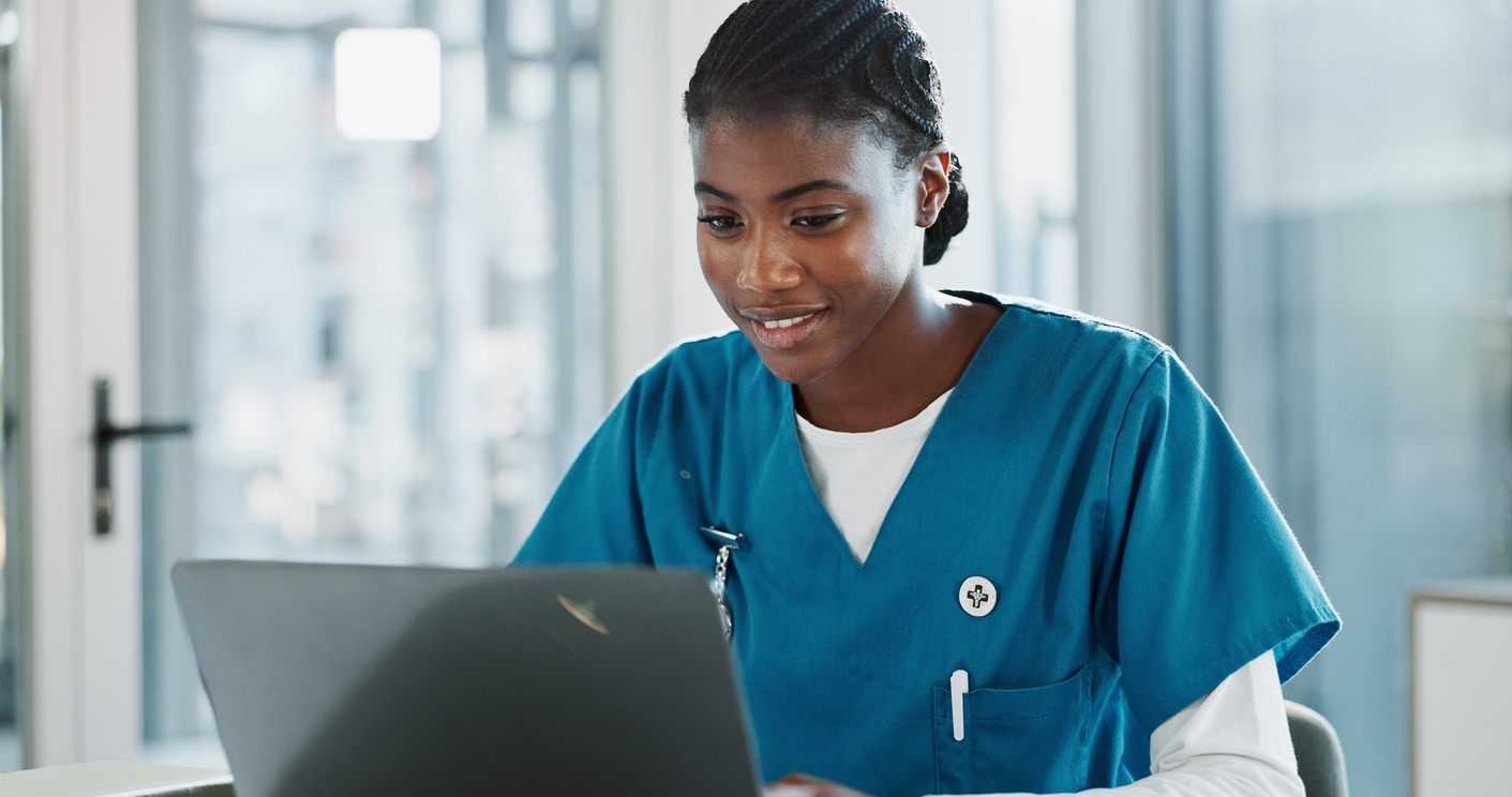 Nursing student completing work on laptop