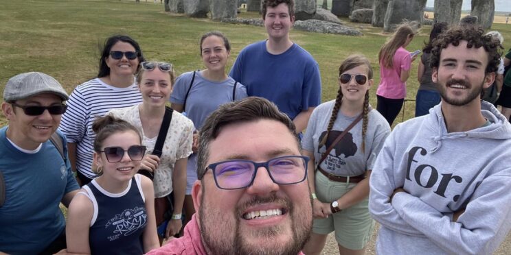 Peyton Jenkins takes a picture with the Great Books Study Abroad group in front of Stonehenge.
