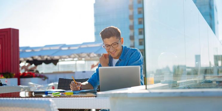 Student Studying on Laptop on Roof Outside