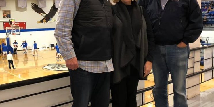 l-r: Tommy Tabor, his wife Robin and alumnus Tim Lee pose before a Faulkner Eagles basketball Homecoming game.