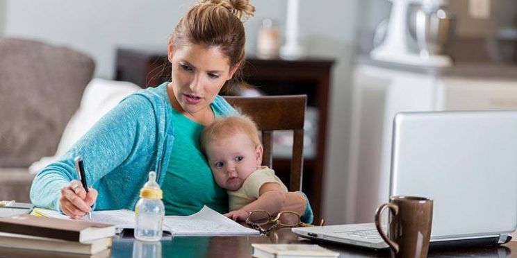 online Student Holding Child While Studying